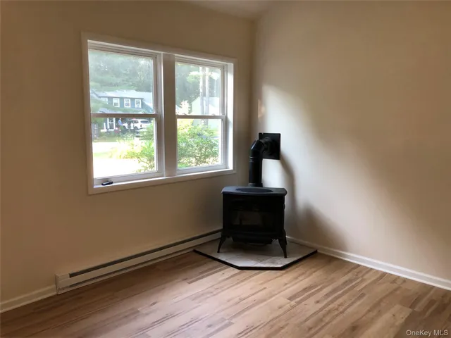 a room with a window and a wooden floor