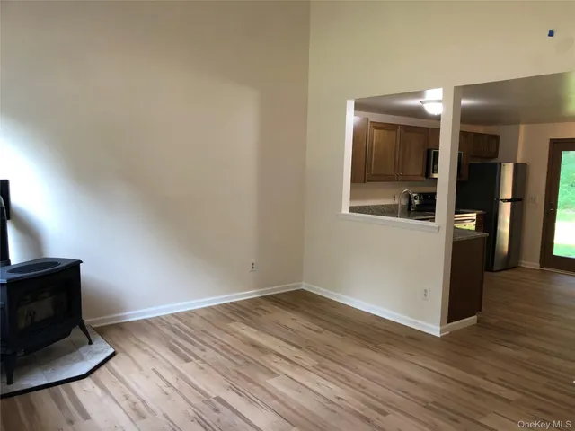 a view of a livingroom with wooden floor and a flat screen tv