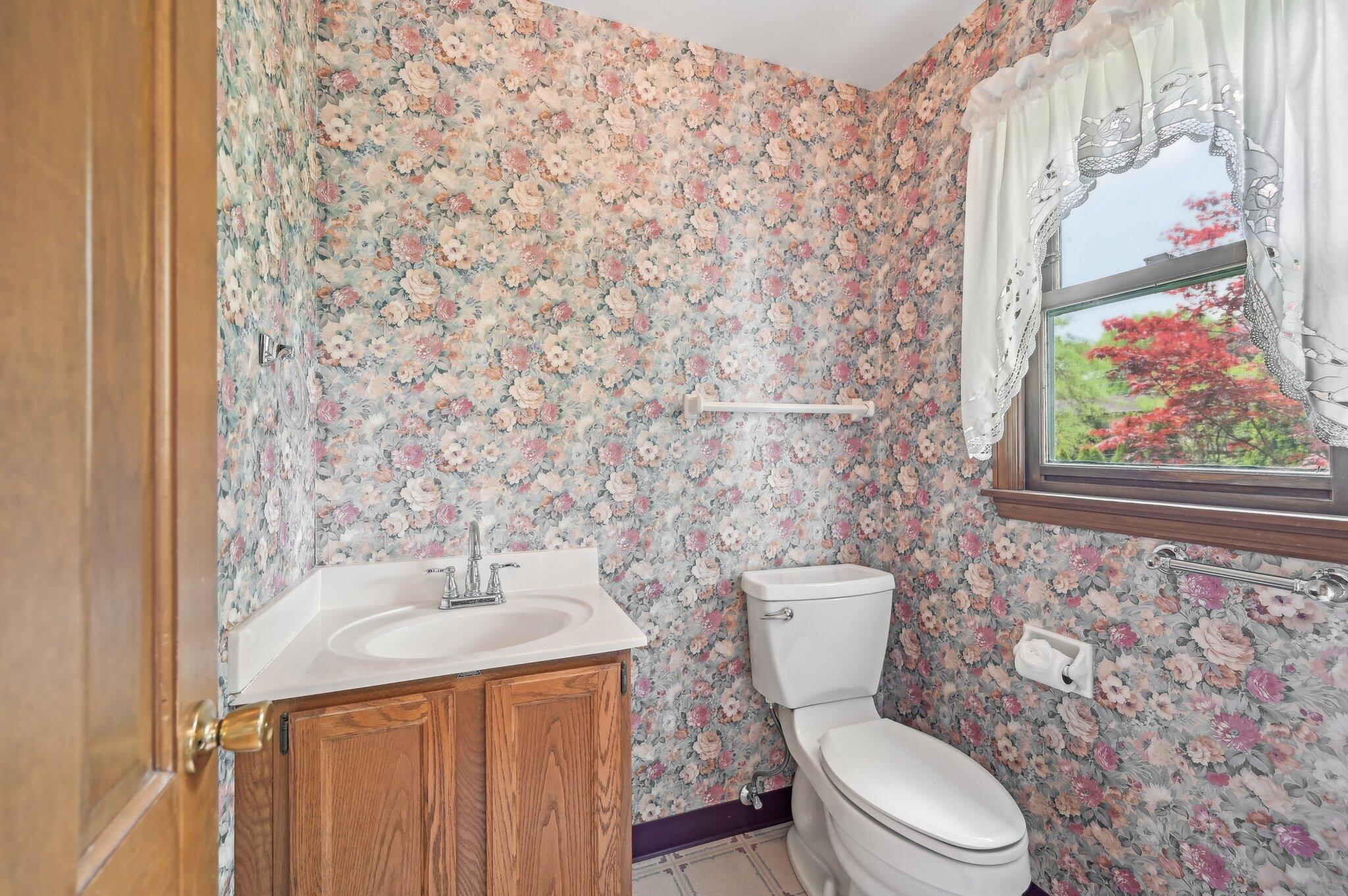 5917 Rocky Rill Road Columbus, OH 43235 - Photo 21 of 47 Charming half bath featuring a single-sink vanity, updated fixtures, and natural light through a window framed with lace-trimmed curtains.