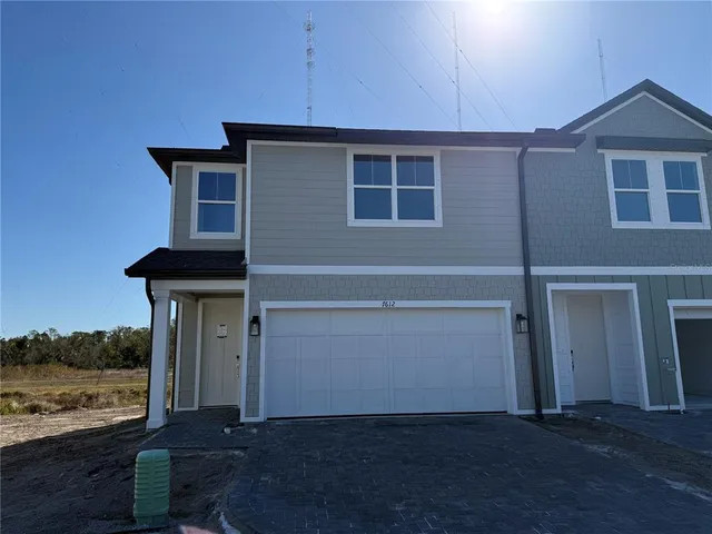 a front view of a house with ocean