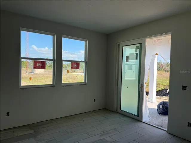 a kitchen that has a lot of white cabinets and stainless steel appliances
