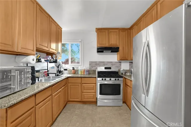 a kitchen with stainless steel appliances a refrigerator and a sink