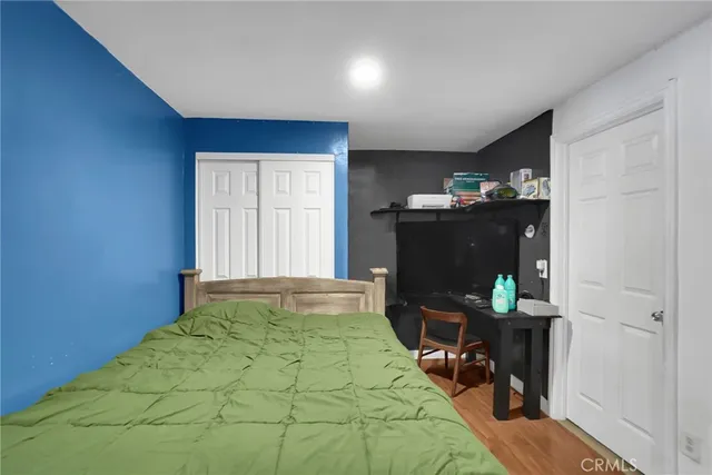 a bedroom with a bed and a dresser