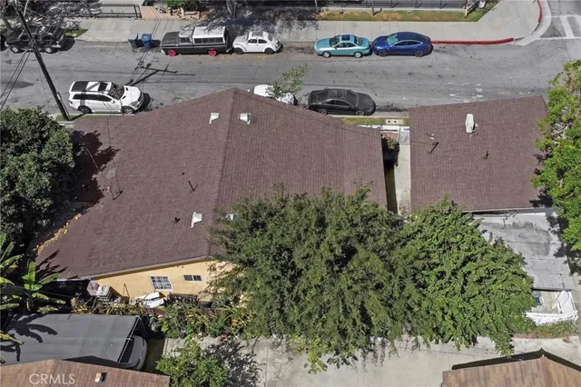 an aerial view of a house with garden space and street view