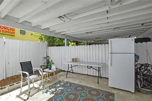 a view of a house with backyard and parking