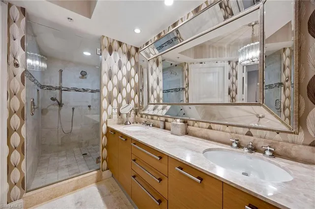 a bathroom with a granite countertop sink mirror and shower
