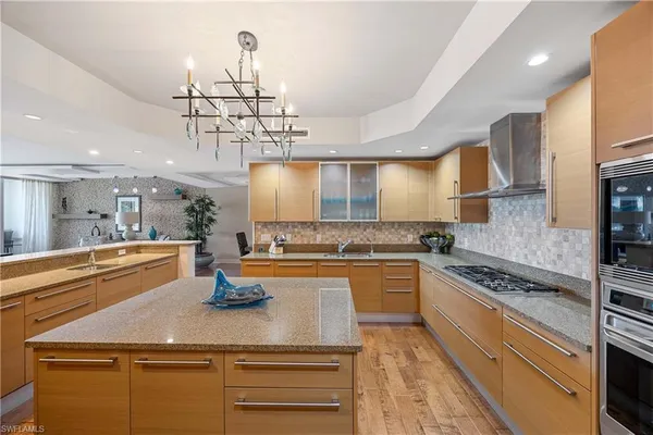 a kitchen with a sink a stove top oven a counter space and cabinets