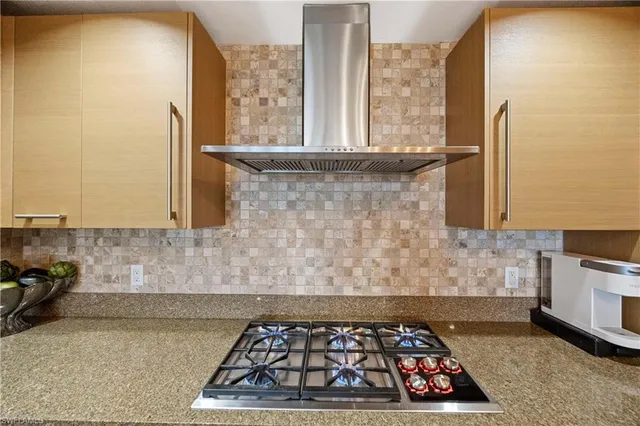a kitchen with wooden cabinets and a stove top oven