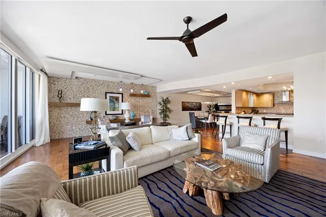 a living room with furniture and view of kitchen