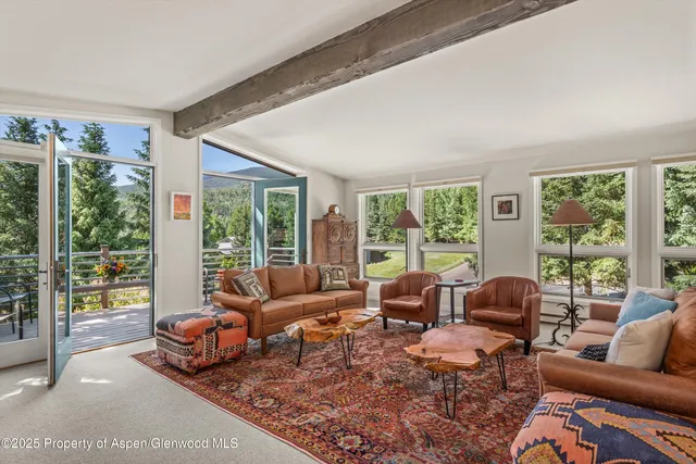 a living room with furniture and large windows