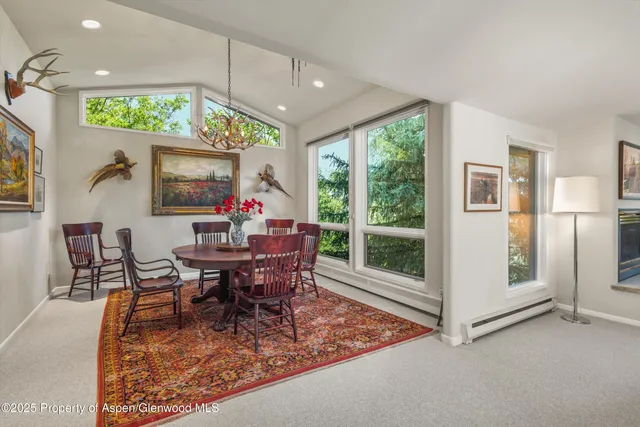 a view of a dining room with furniture wooden floor and a chandelier
