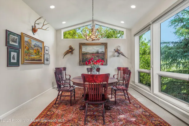 a living room with furniture a dining table and a piano table
