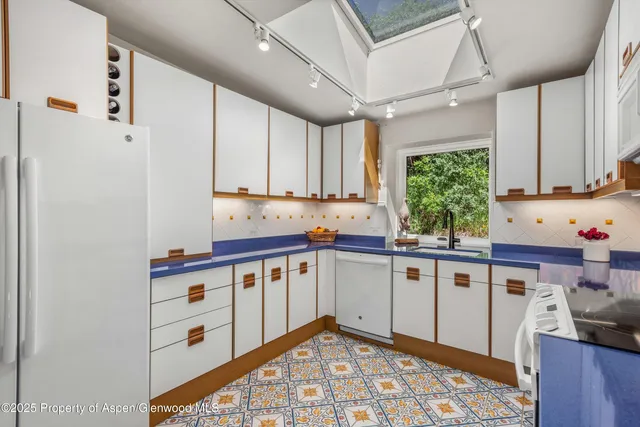 a kitchen with stainless steel appliances a refrigerator and a counter space