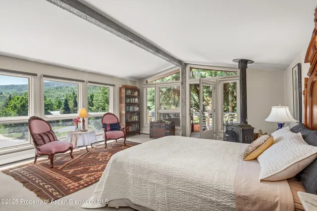 a bedroom with furniture and a window