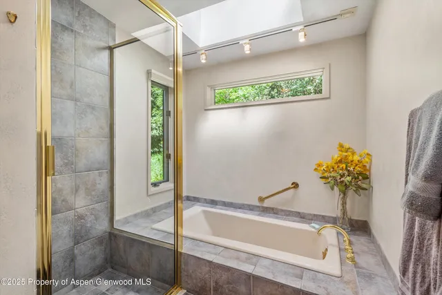 a bedroom with bed and a book shelf