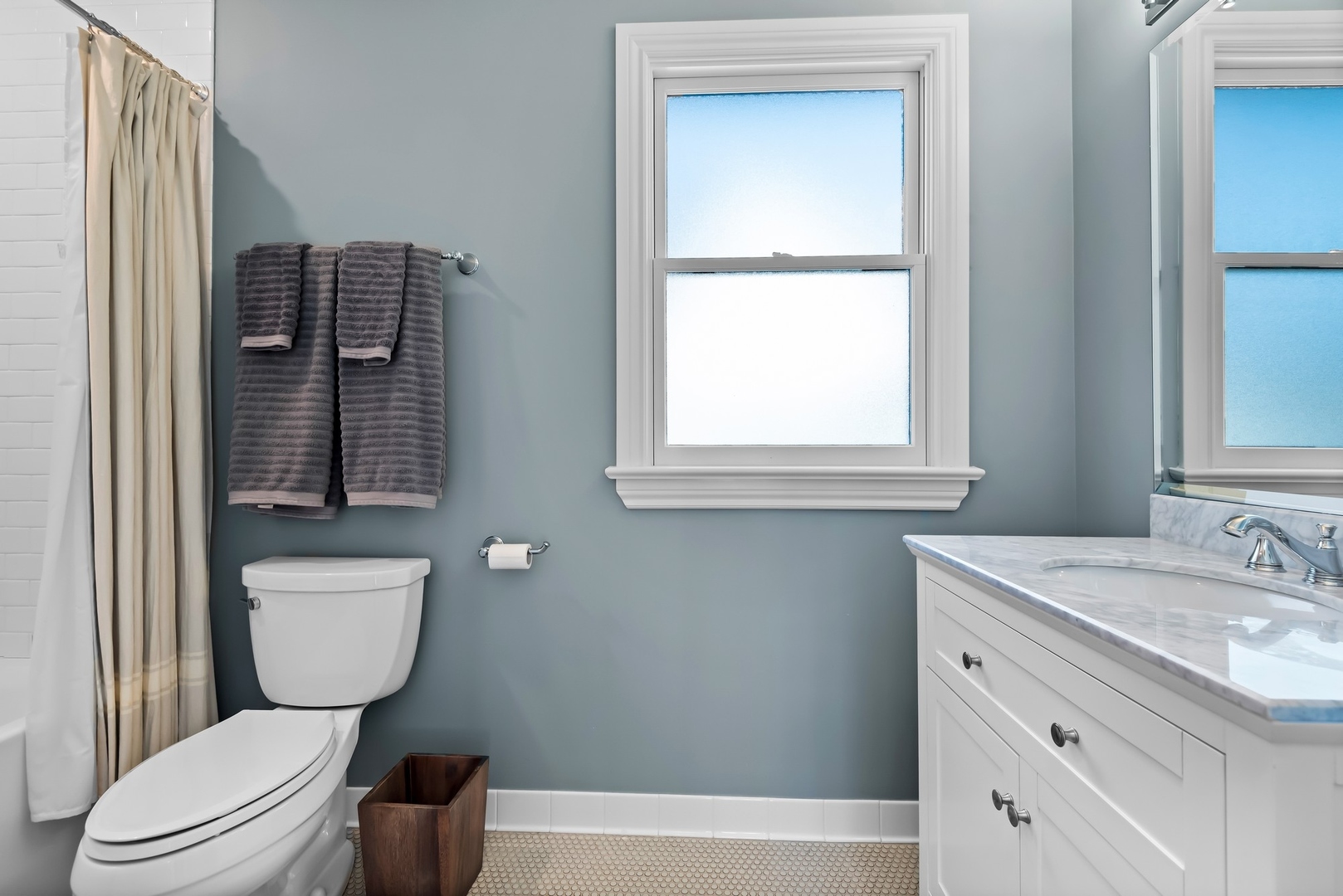 Undisclosed Address Evanston, IL 60201 - Photo 18 of 27 a bathroom with a toilet a sink a window and mirror