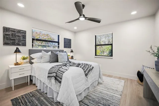 a bedroom with a large bed and a chandelier