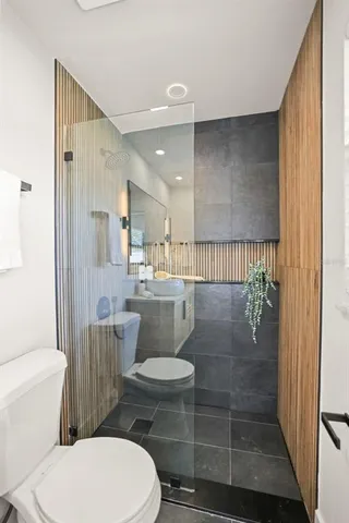 a bedroom with a bed and painting on the wall