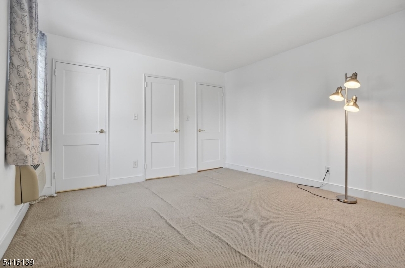 10 Troy Drive, Unit 10A Springfield, NJ 07081 - Photo 11 of 23 a view of an empty room with a fan