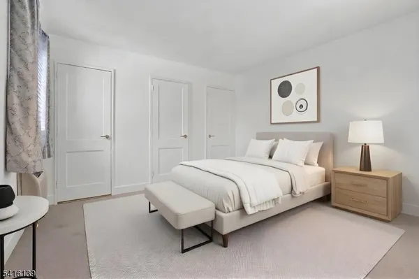 a spacious bedroom with a bed and a table in it