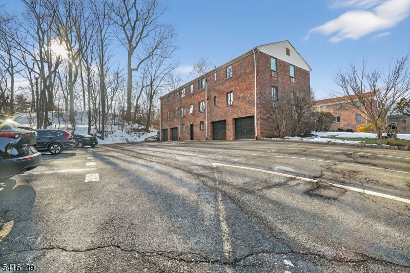 10 Troy Drive, Unit 10A Springfield, NJ 07081 - Photo 17 of 23 a front view of a building with trees