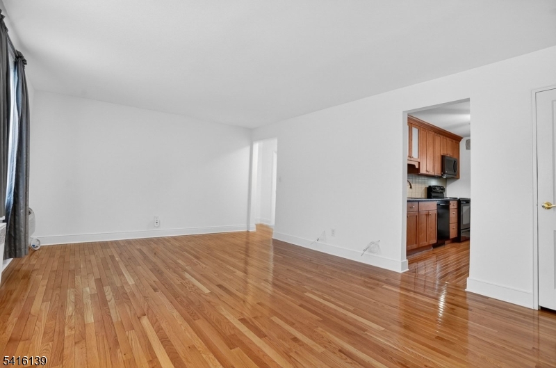 10 Troy Drive, Unit 10A Springfield, NJ 07081 - Photo 2 of 23 a view of empty room with wooden floor