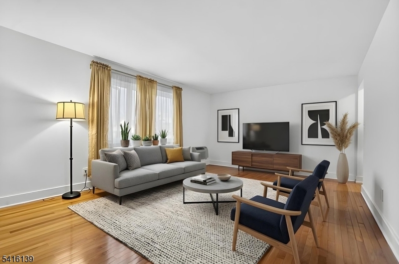 10 Troy Drive, Unit 10A Springfield, NJ 07081 - Photo 3 of 23 a living room with furniture and a flat screen tv