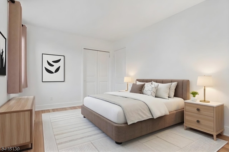 10 Troy Drive, Unit 10A Springfield, NJ 07081 - Photo 9 of 23 a bedroom with a bed and painting on the wall