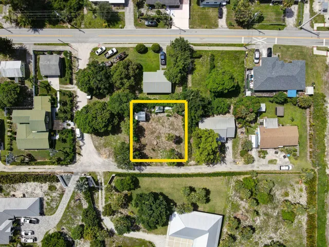 an aerial view of a house with a yard and lake view