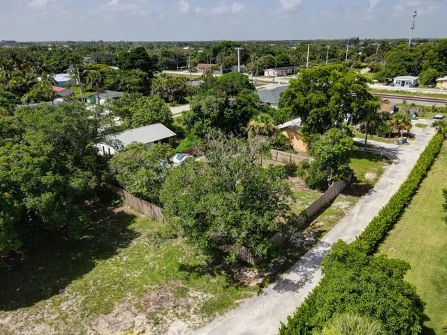 an aerial view of a house with a yard and lake view