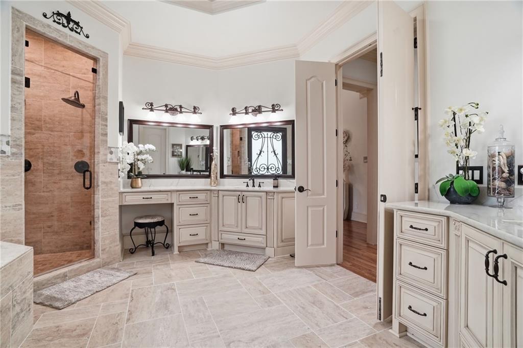 8340 Colonial Place Duluth, GA 30097 - Photo 27 of 74 a spacious bathroom with a double vanity sink and a mirror