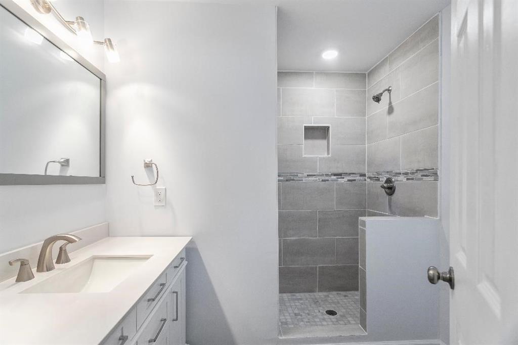 4144 Canby Lane Decatur, GA 30035 - Photo 5 of 6 a bathroom with a shower sink and mirror
