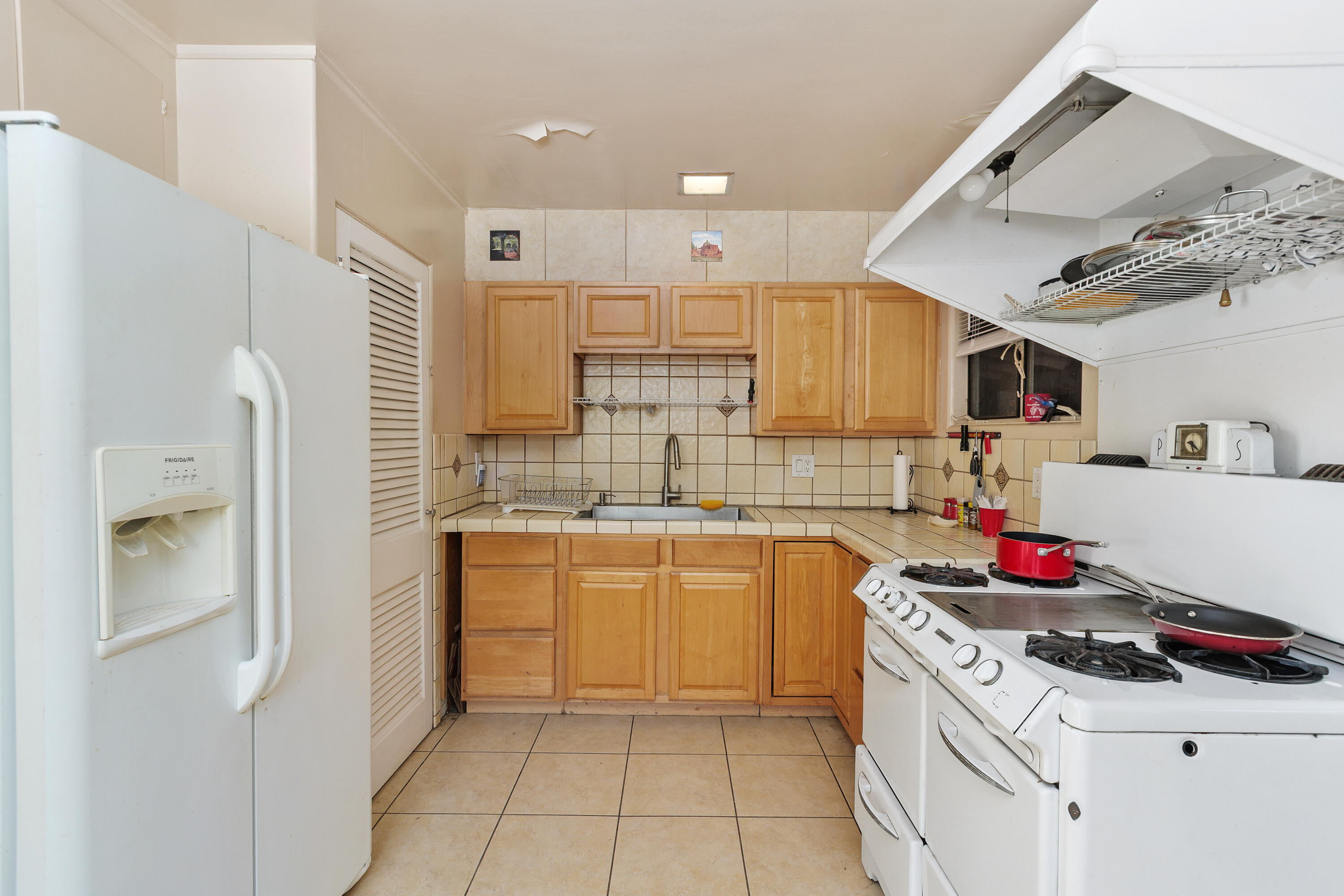1077 South Riverside Drive Palm Springs, CA 92264 - Photo 18 of 35 a kitchen with a sink stove and cabinets
