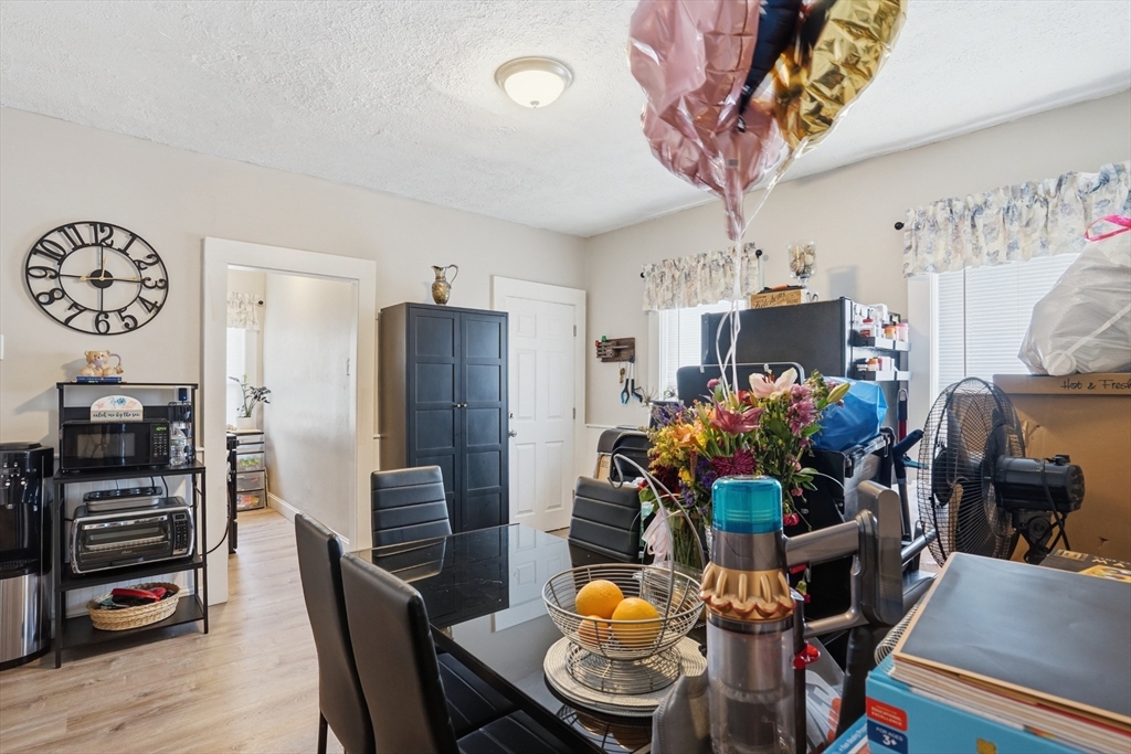 196 Irving Street Fall River, MA 02723 - Photo 24 of 34 a dining room filled chandelier and wooden floor