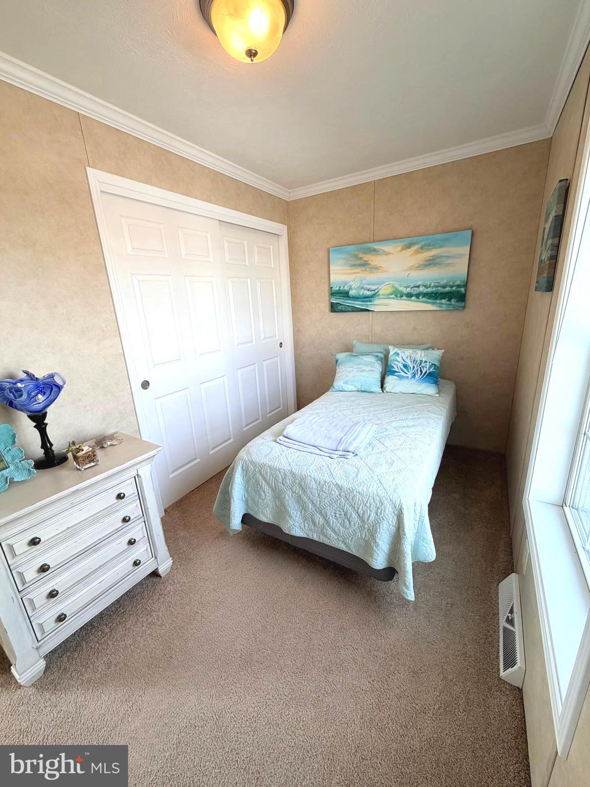 38025 Rabbit Road, Unit 101 Ocean View, DE 19970 - Photo 59 of 112 a bedroom with a bed and a window