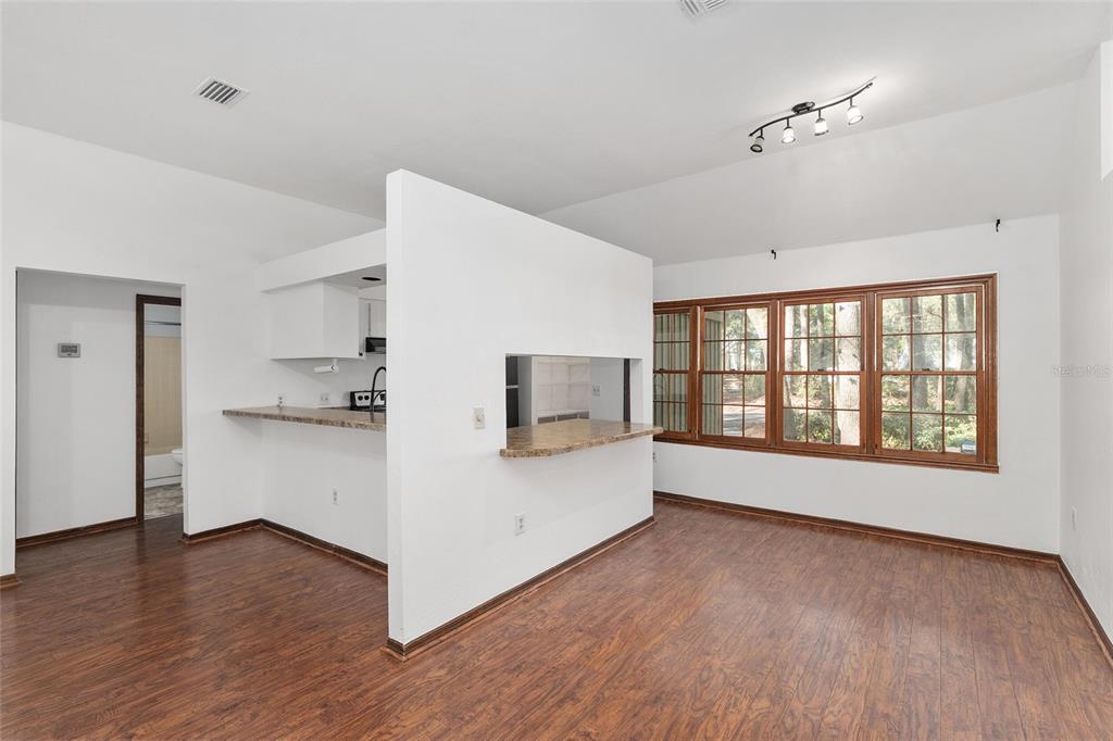 8305 Southwest 46 Lane Gainesville, FL 32608 - Photo 17 of 65 a view of a big room with wooden floor and windows