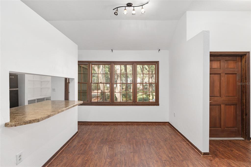 8305 Southwest 46 Lane Gainesville, FL 32608 - Photo 18 of 65 an empty room with wooden floor and windows