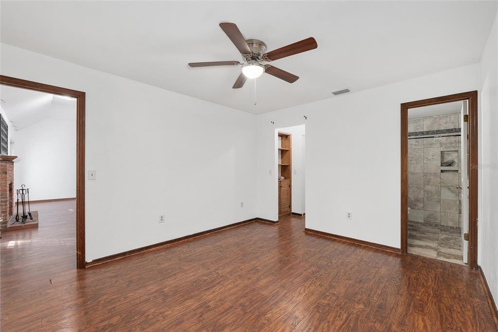 8305 Southwest 46 Lane Gainesville, FL 32608 - Photo 29 of 65 an empty room with wooden floor and a ceiling fan