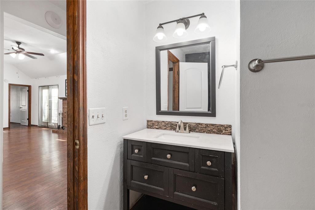 8305 Southwest 46 Lane Gainesville, FL 32608 - Photo 39 of 65 a bathroom with a sink vanity and a mirror