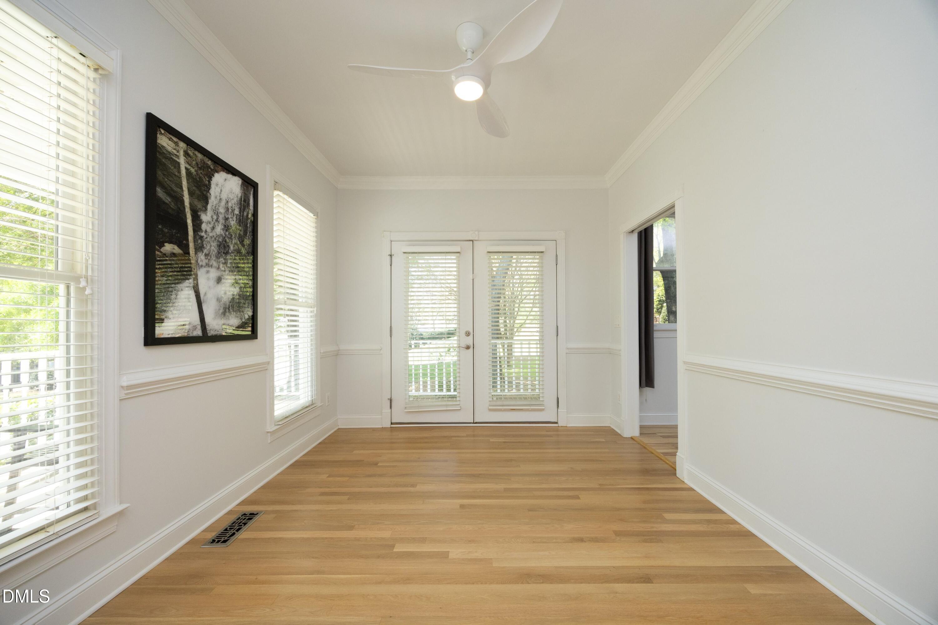 1427 Moosecreek Drive Raleigh, NC 27614 - Photo 14 of 51 a view of an empty room with wooden floor and a window