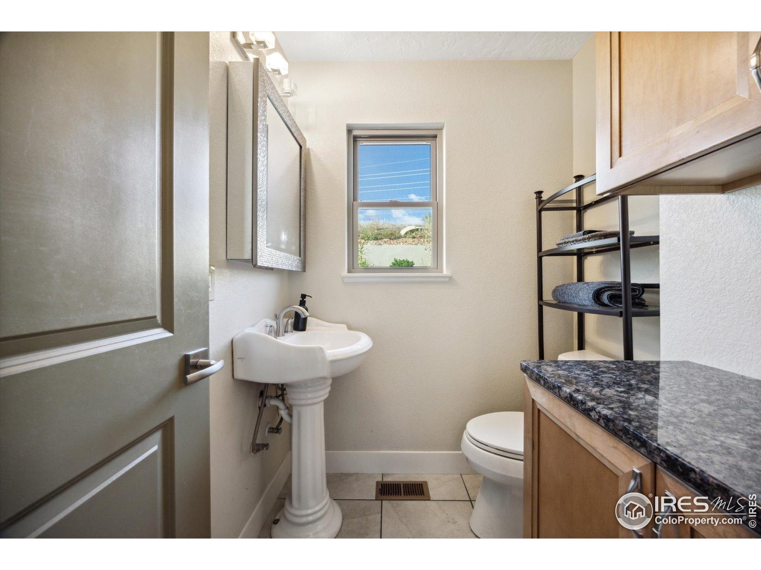 403 Double Tree Drive Greeley, CO 80634 - Photo 19 of 49 a bathroom with a sink a toilet and mirror