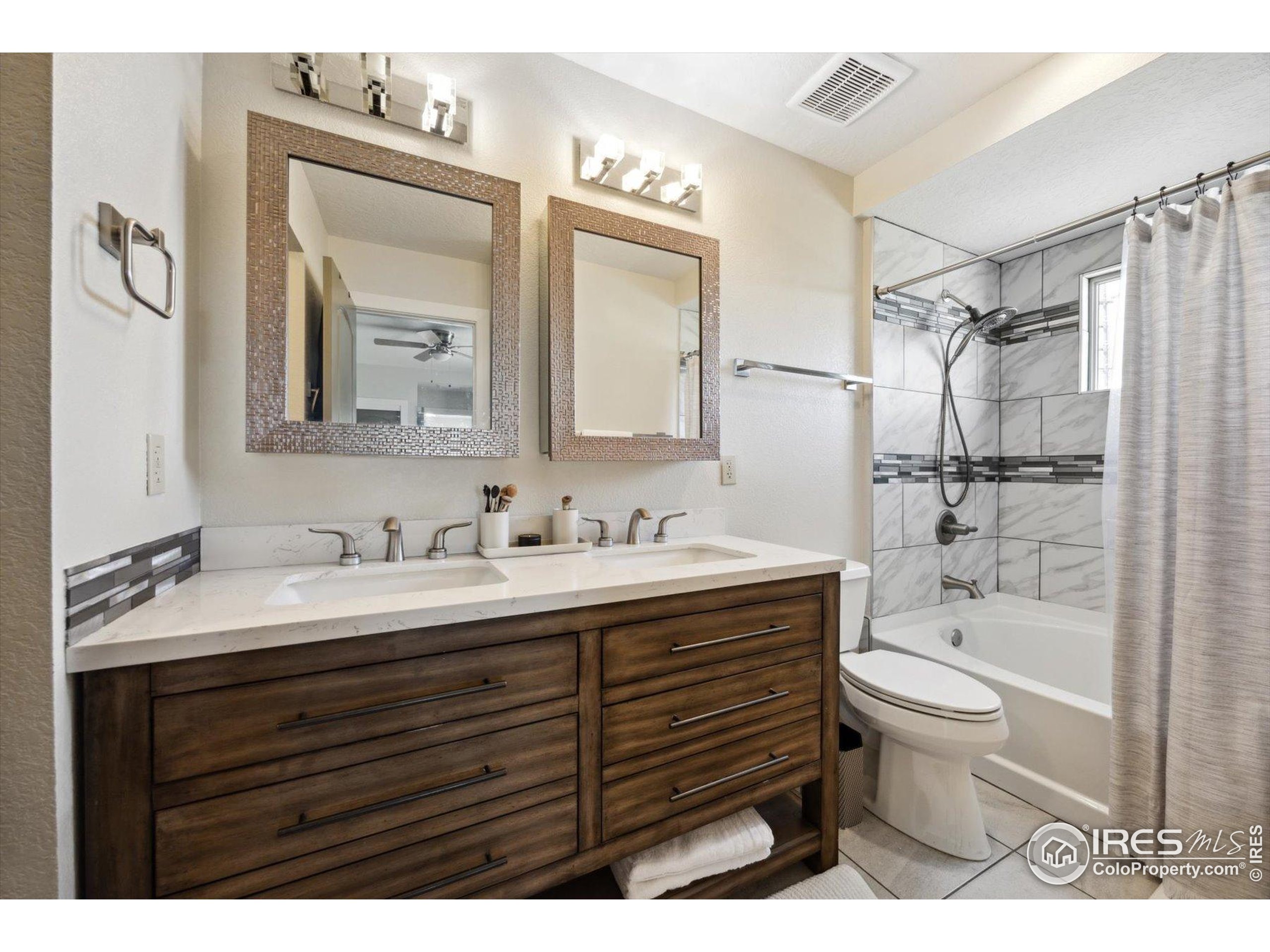 403 Double Tree Drive Greeley, CO 80634 - Photo 27 of 49 a bathroom with a granite countertop sink toilet a large mirror and shower
