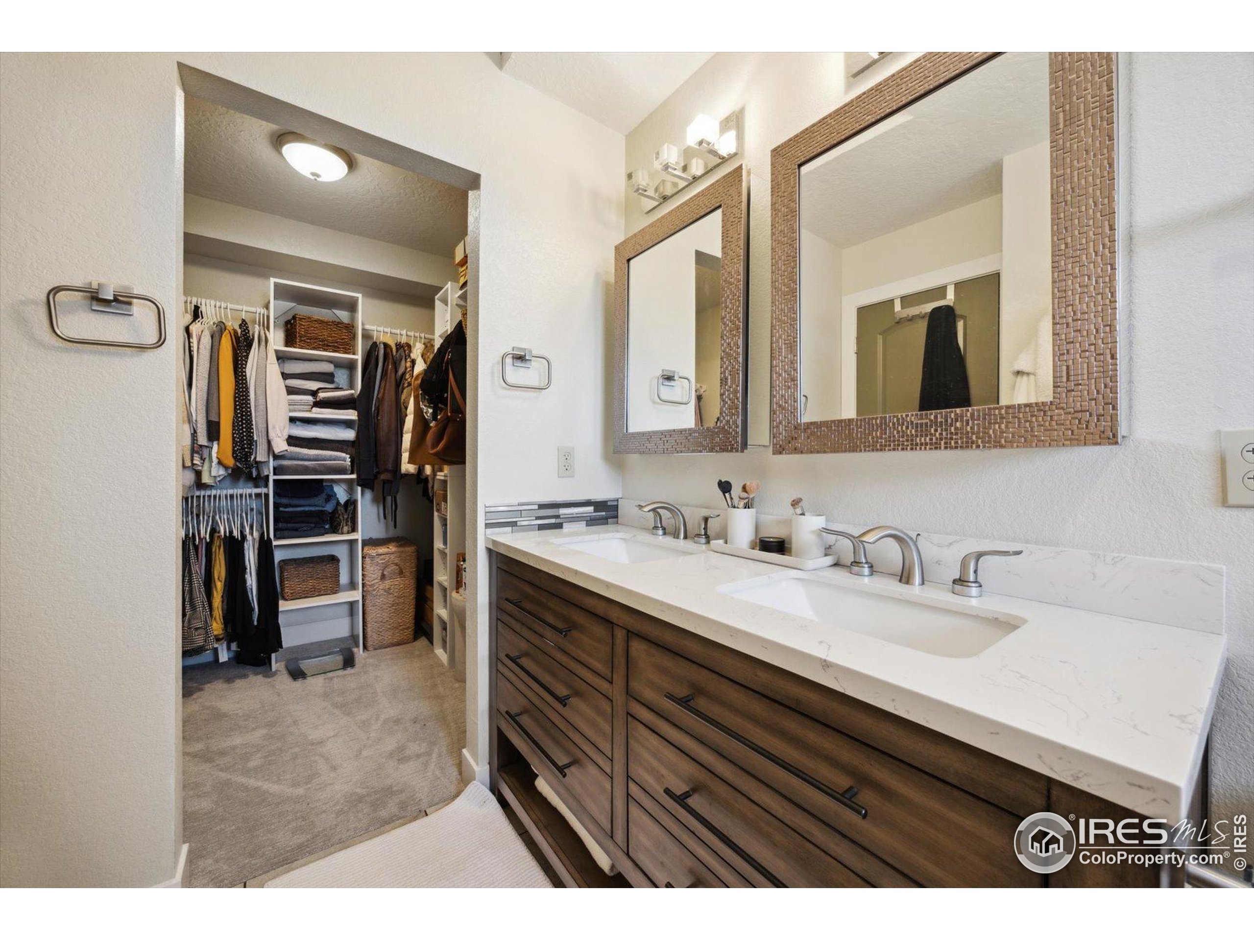 403 Double Tree Drive Greeley, CO 80634 - Photo 28 of 49 a en suite bathroom with a double vanity sink and a mirror