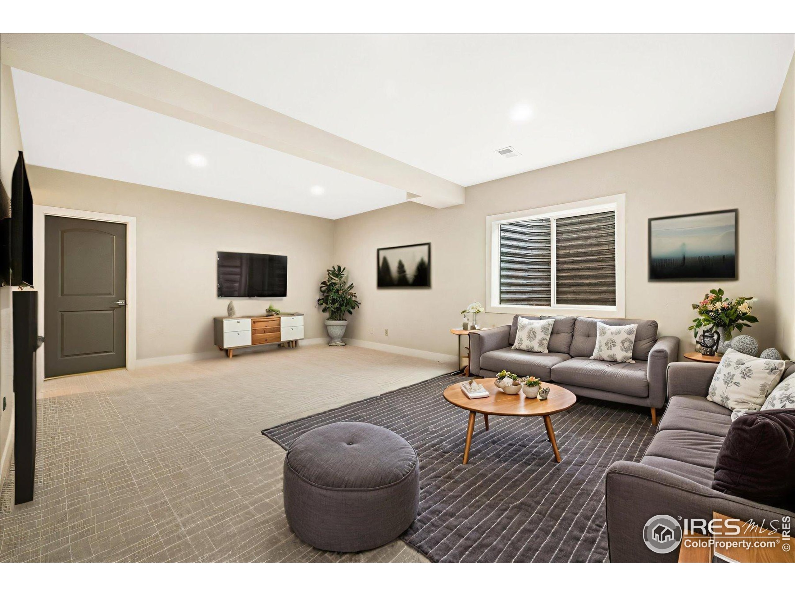 403 Double Tree Drive Greeley, CO 80634 - Photo 30 of 49 a living room with furniture and a flat screen tv