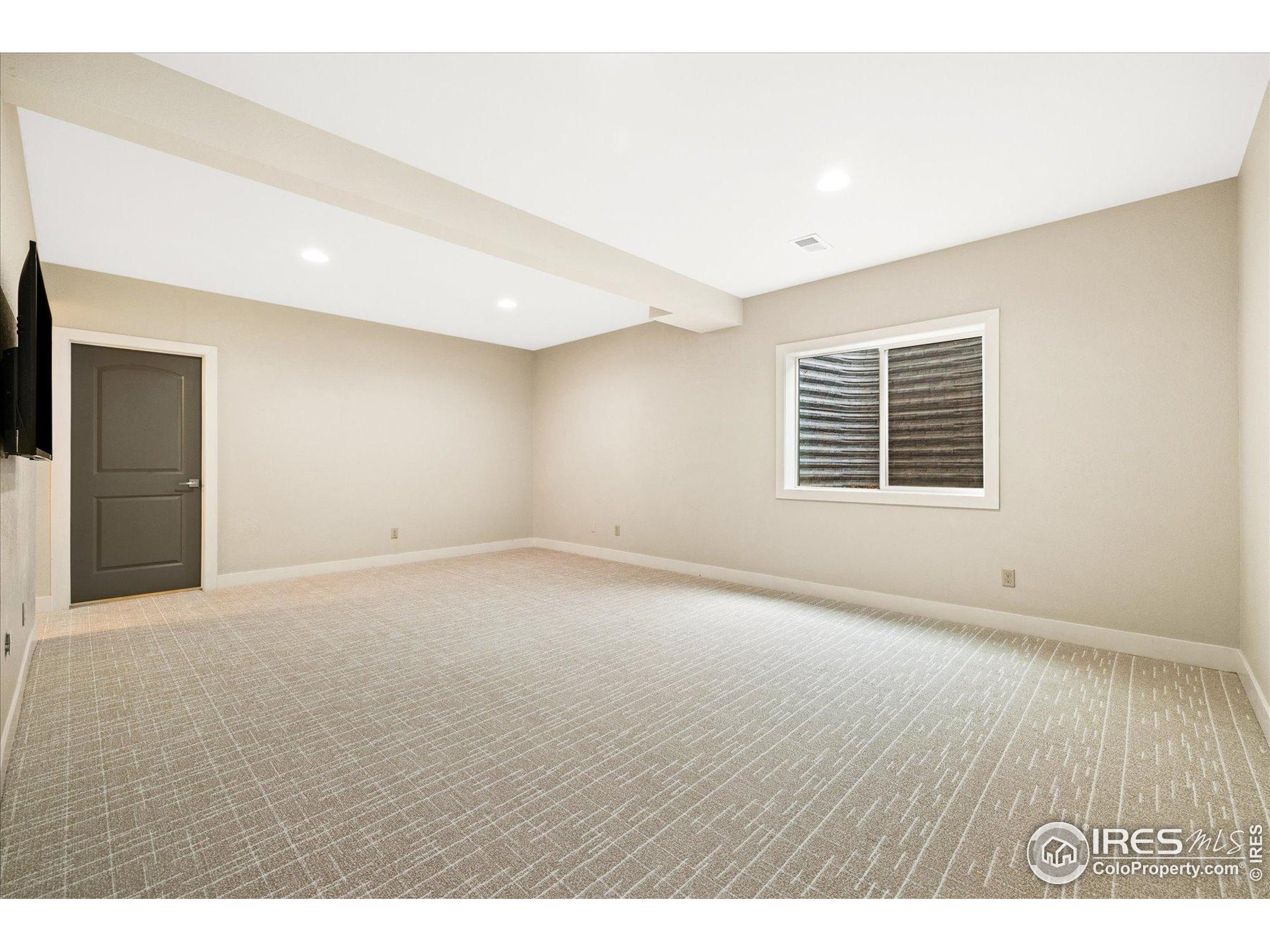 403 Double Tree Drive Greeley, CO 80634 - Photo 31 of 49 a view of an empty room with wooden floor and a window