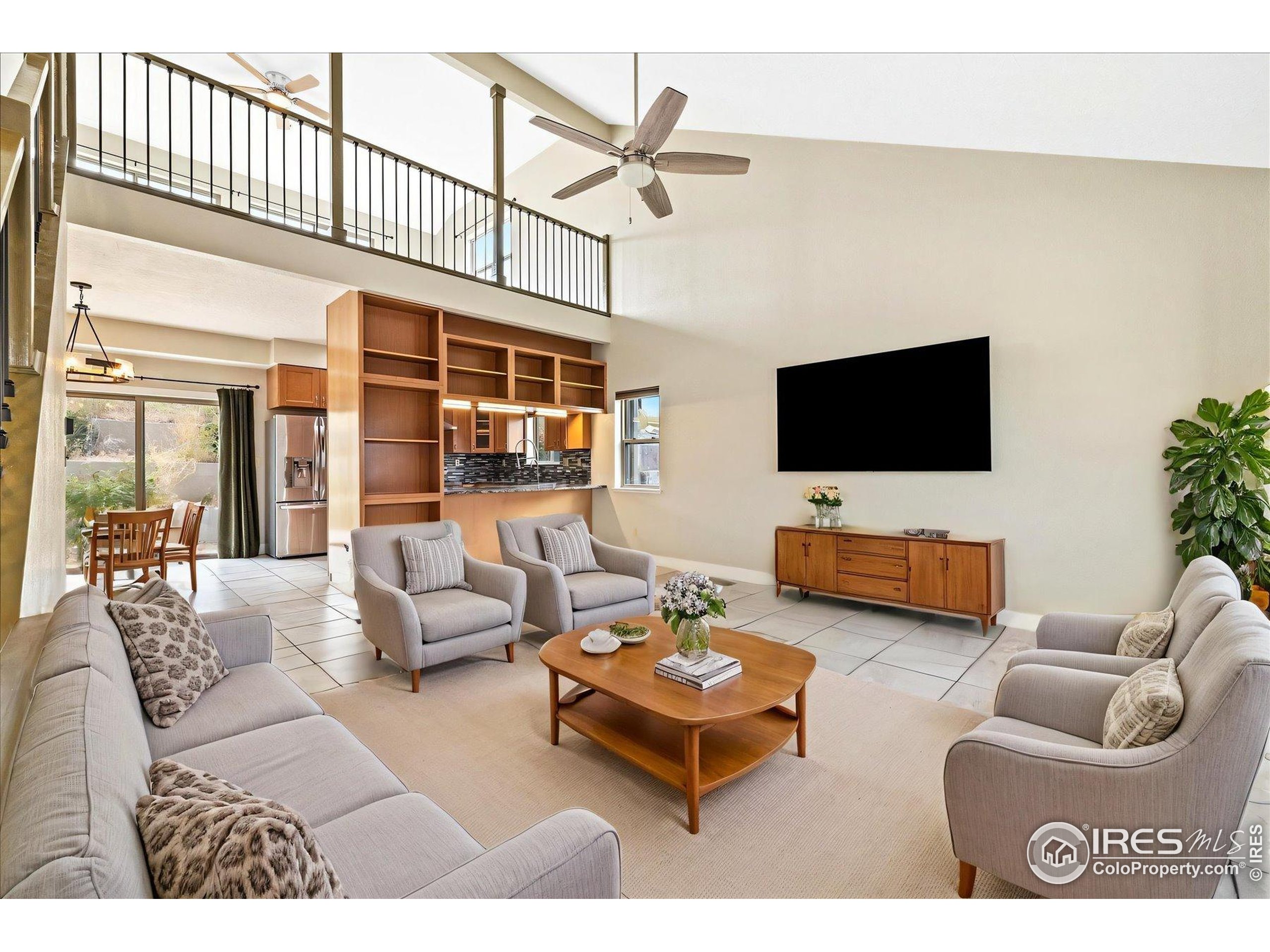403 Double Tree Drive Greeley, CO 80634 - Photo 6 of 49 a living room with furniture and a flat screen tv