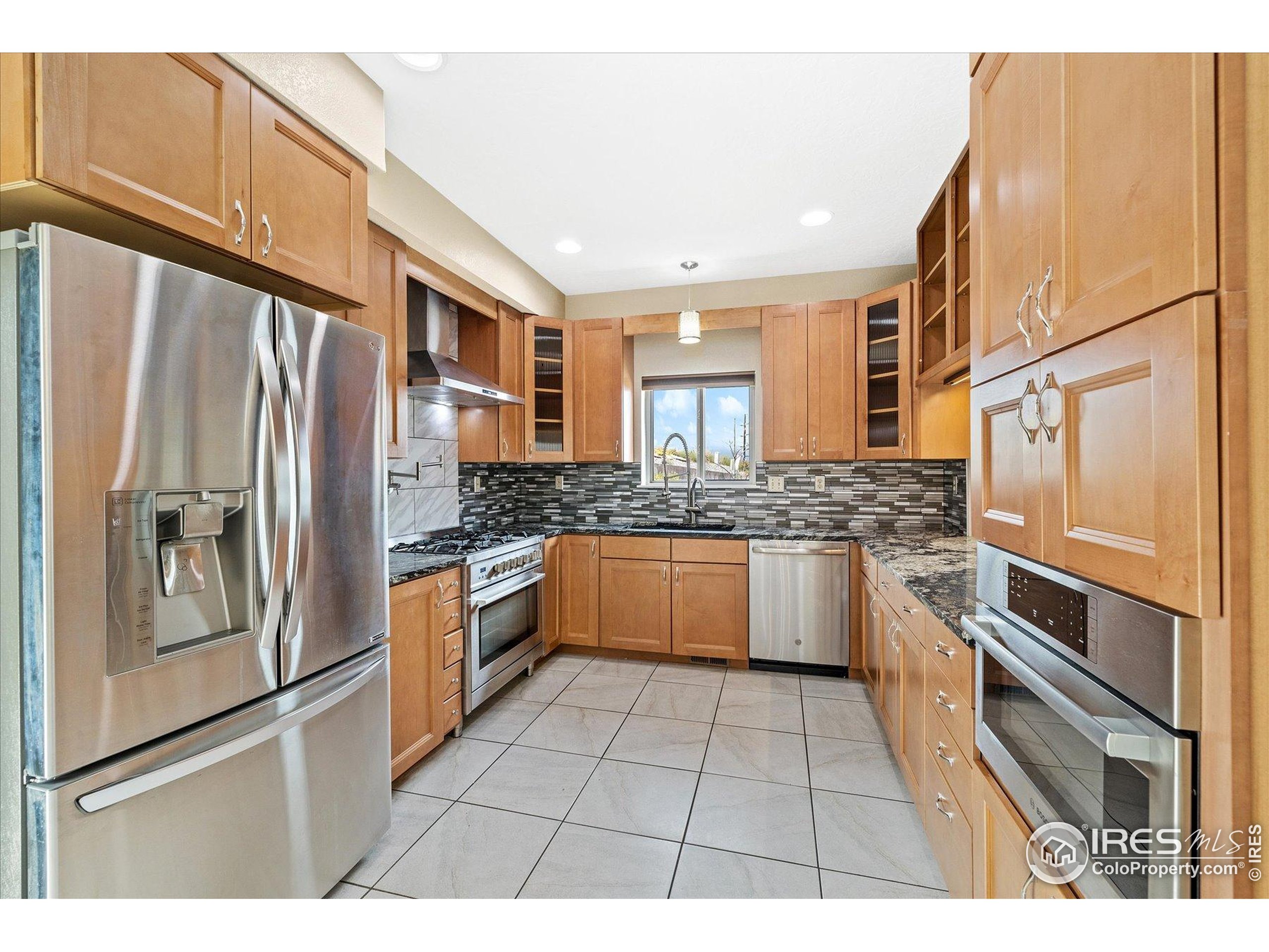 403 Double Tree Drive Greeley, CO 80634 - Photo 10 of 49 a kitchen with stainless steel appliances granite countertop a refrigerator and a stove
