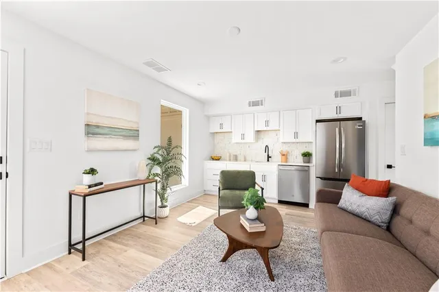 a kitchen with stainless steel appliances granite countertop a refrigerator and a sink
