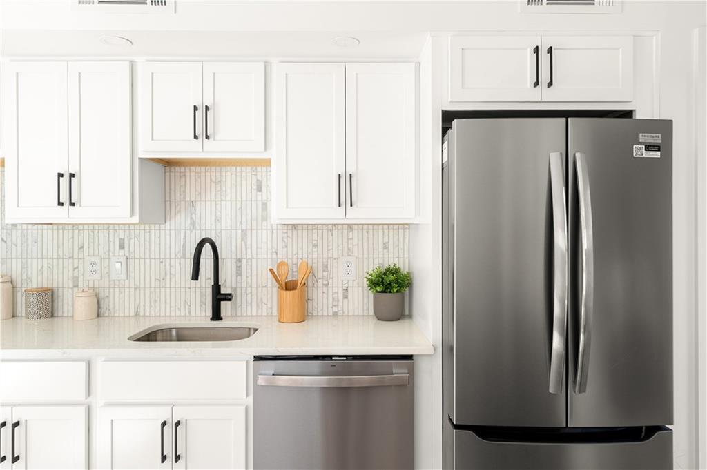 845 Ormewood Terrace Southeast, Unit B Atlanta, GA 30316 - Photo 14 of 32 a kitchen with stainless steel appliances granite countertop a refrigerator and a sink