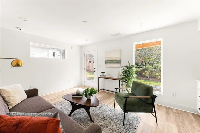 a living room with furniture and wooden floor